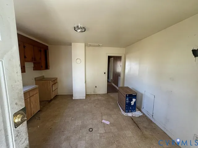 a view of an empty room with a fireplace