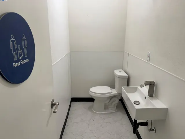 a white toilet sitting next to a bathroom sink