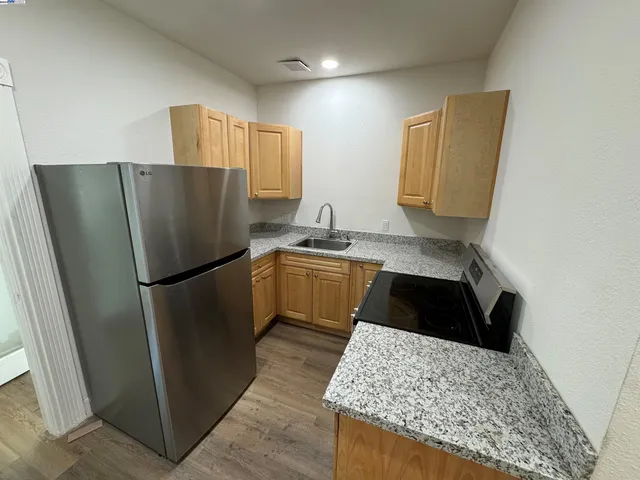 a kitchen with a refrigerator and a sink