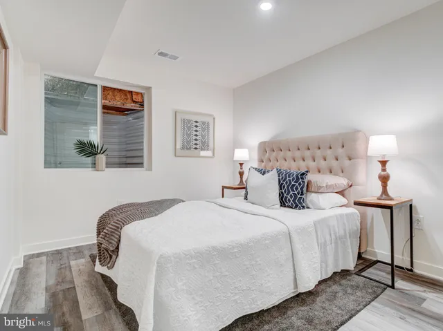 a bedroom with bed and a night stand