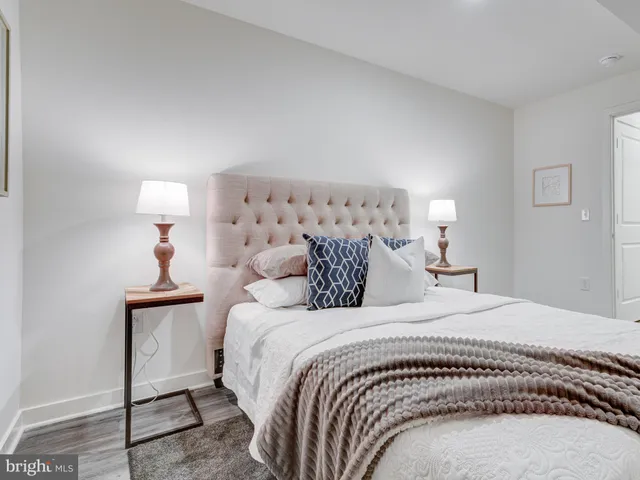 a bedroom with a bed and a lamp