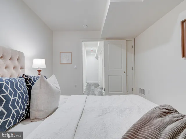 a bedroom with a bed and a lamp