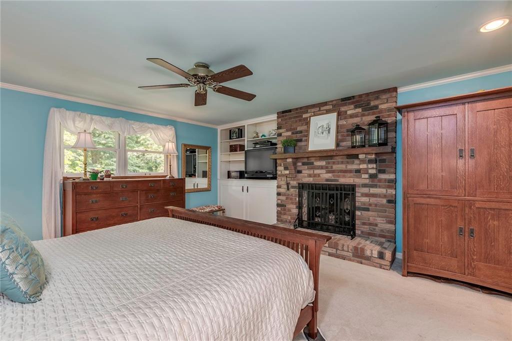 2092 Mercer Road New Brighton, PA 15066 - Photo 12 of 25 Retreat into the master suite complete with a gas fireplace, custom built-ins and crown molding overlooking the picturesque backyard