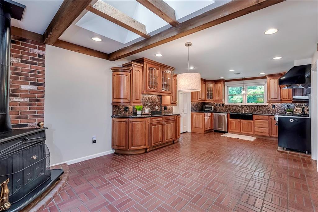2092 Mercer Road New Brighton, PA 15066 - Photo 9 of 25 Custom kitchen includes custom cherry cabinetry and a wood burning stove in the dine-in area
