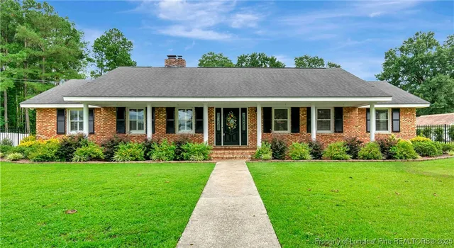 a front view of house with yard and green space