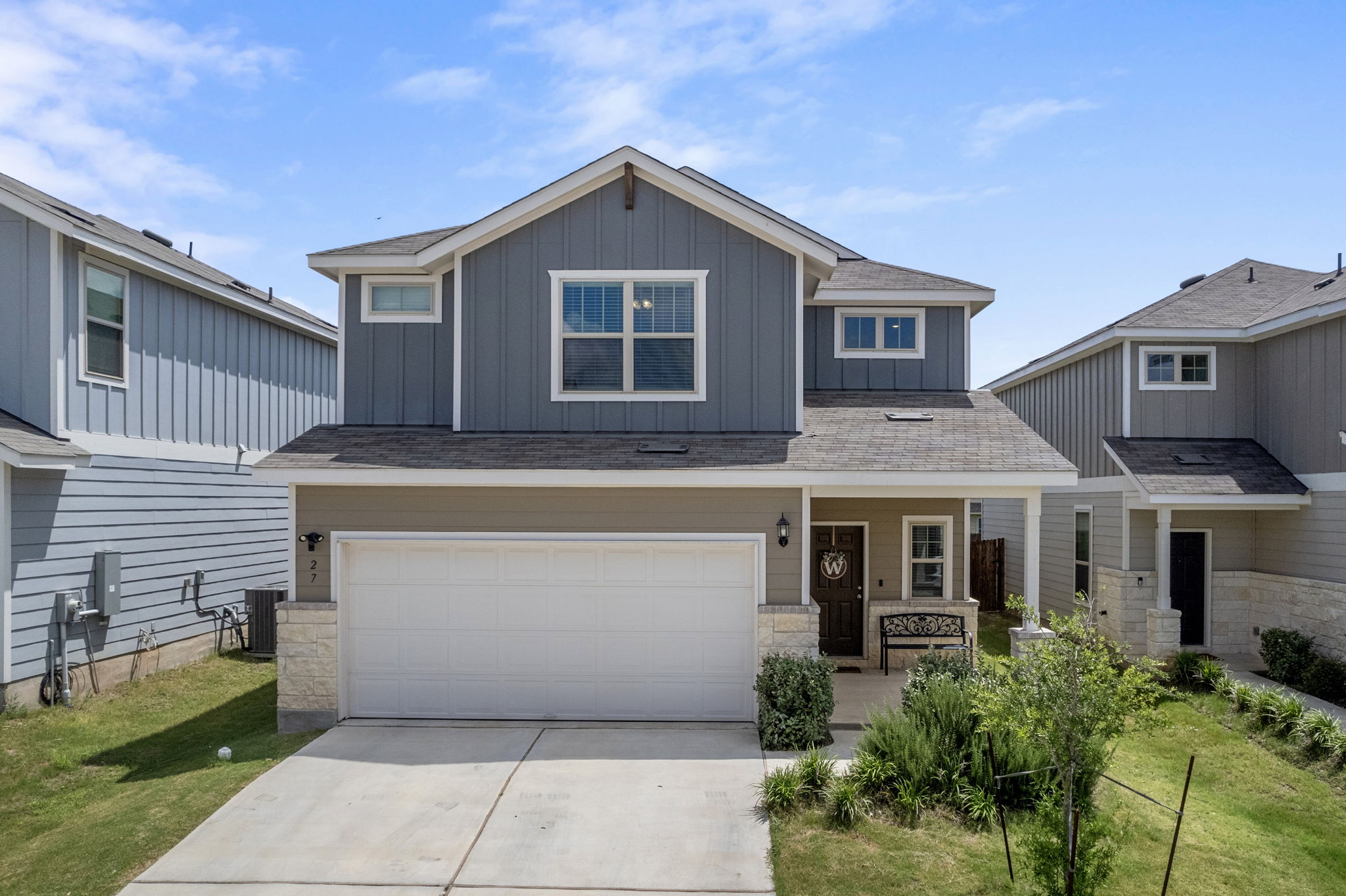 a front view of a house with a garden