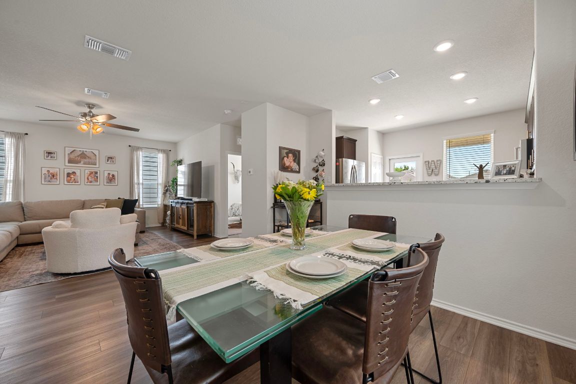 27 Pacific Loon Street Leander, TX 78641 - Photo 11 of 35 a view of a dining room with furniture and wooden floor