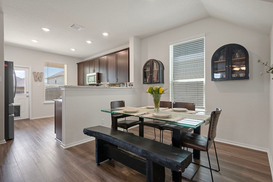27 Pacific Loon Street Leander, TX 78641 - Photo 12 of 35 a view of a dining room with furniture and wooden floor