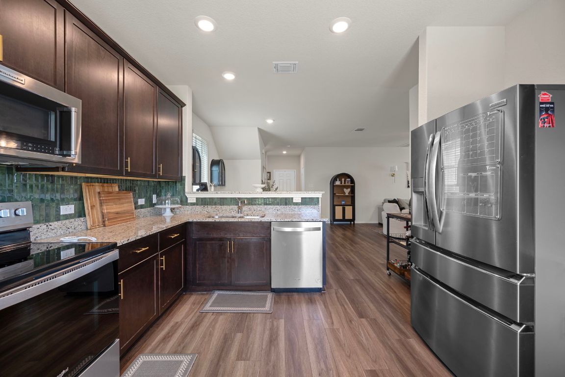 27 Pacific Loon Street Leander, TX 78641 - Photo 16 of 35 a kitchen with a sink stainless steel appliances and cabinets