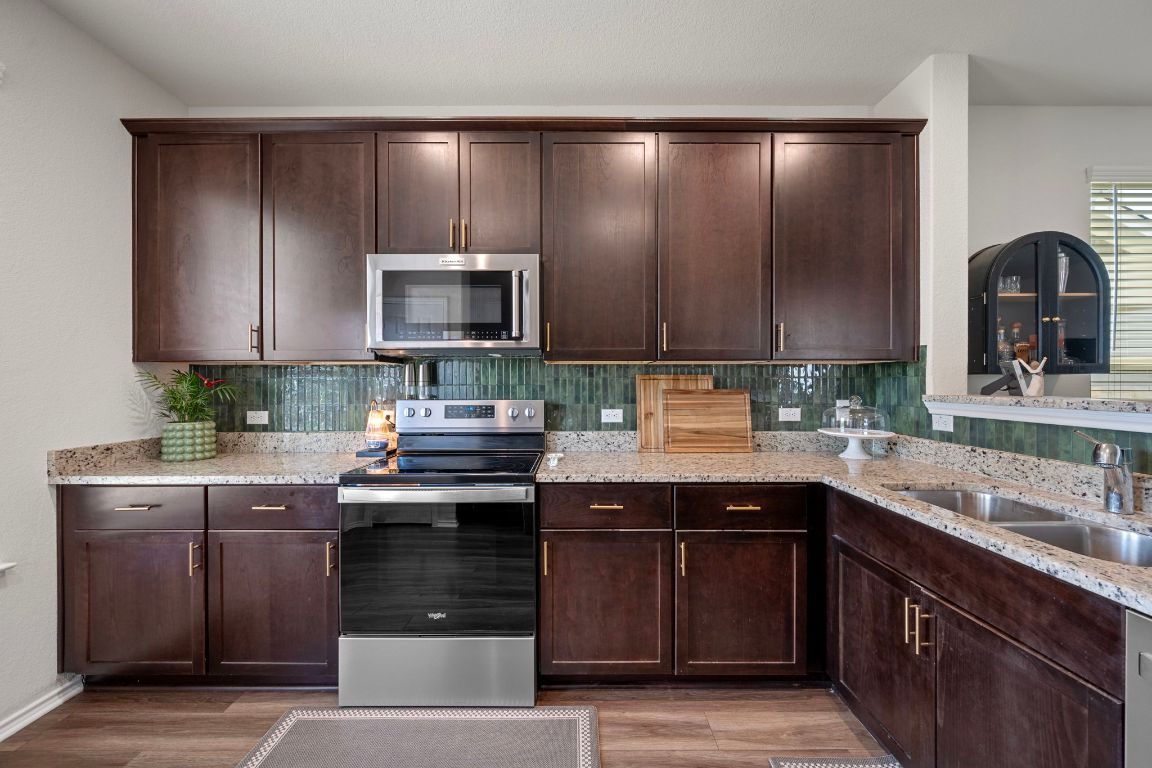 27 Pacific Loon Street Leander, TX 78641 - Photo 17 of 35 a kitchen with a sink and cabinets