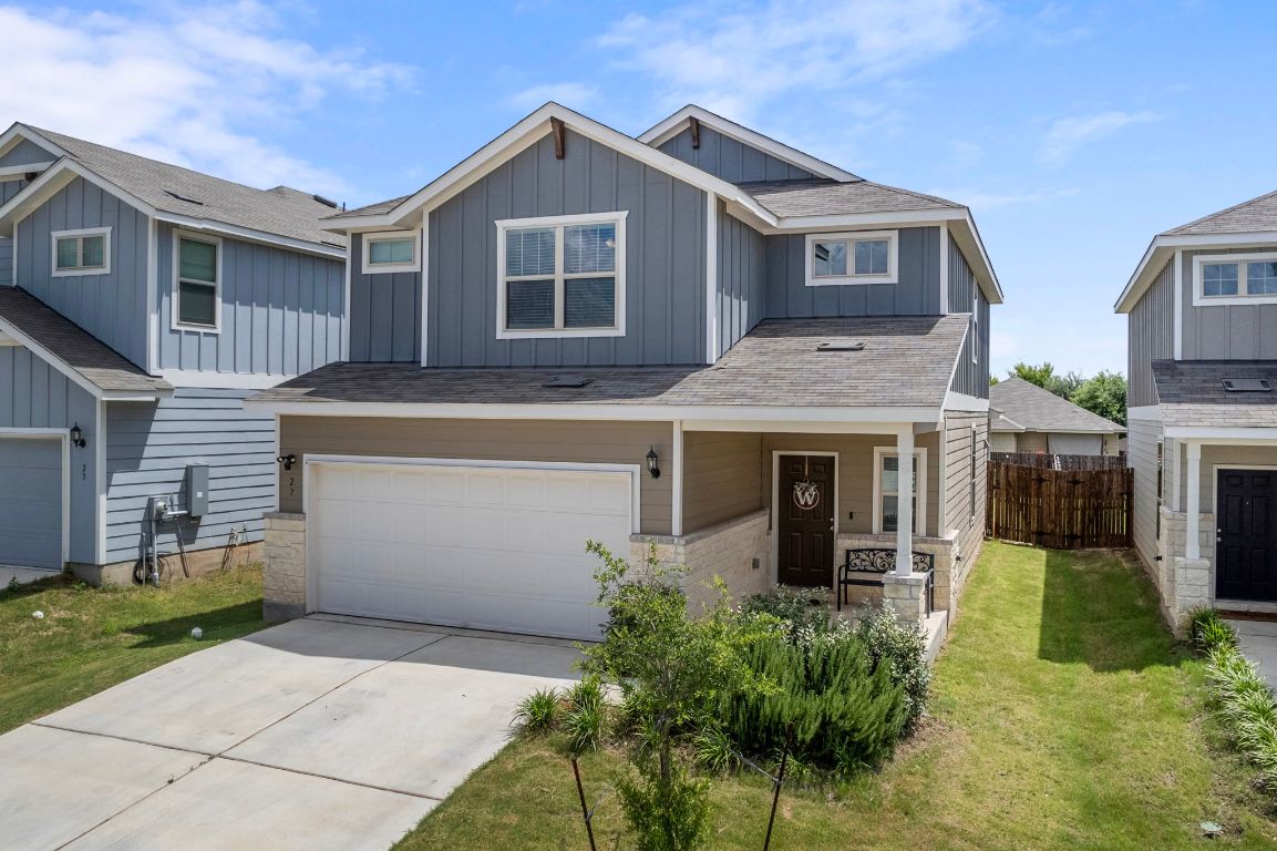 27 Pacific Loon Street Leander, TX 78641 - Photo 2 of 35 a front view of a house with a yard and potted plants