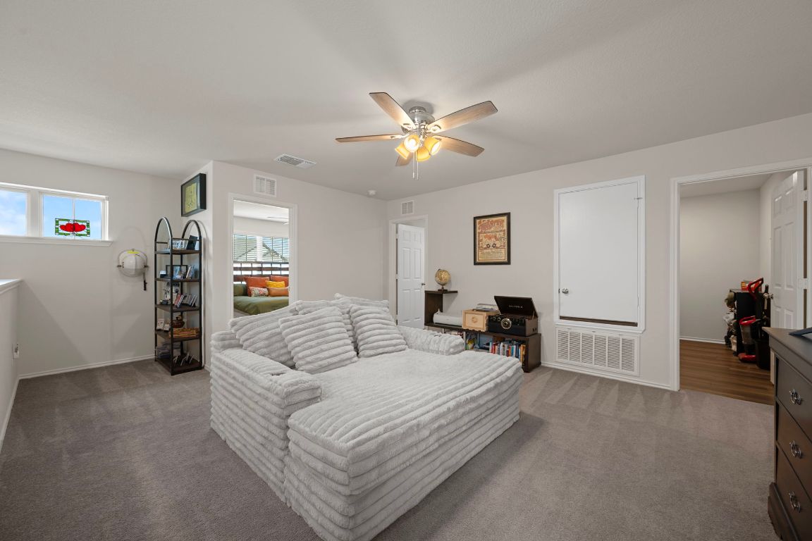 27 Pacific Loon Street Leander, TX 78641 - Photo 21 of 35 a living room with furniture and a flat screen tv