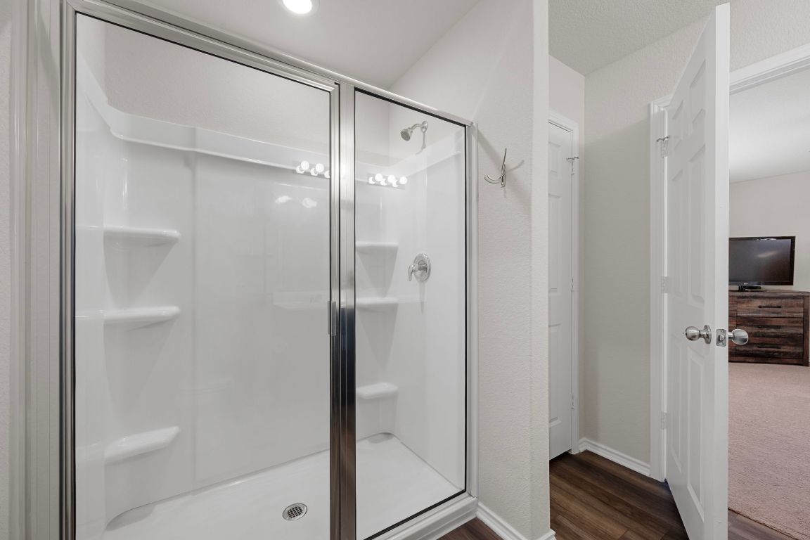27 Pacific Loon Street Leander, TX 78641 - Photo 26 of 35 a bathroom with a shower and a glass door