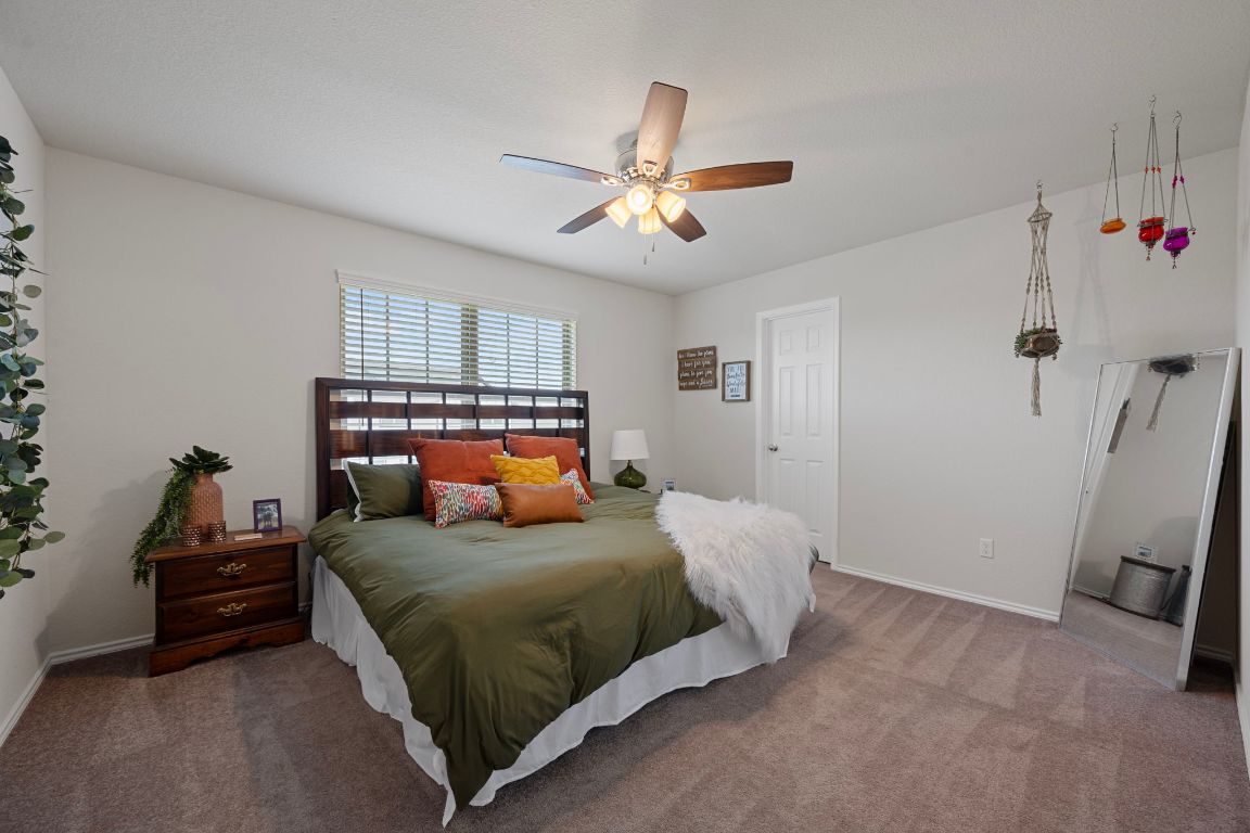 27 Pacific Loon Street Leander, TX 78641 - Photo 27 of 35 a bedroom with a bed and a ceiling fan