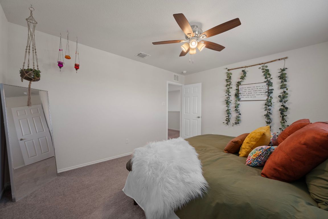 27 Pacific Loon Street Leander, TX 78641 - Photo 28 of 35 a bed room with a bed and a ceiling fan
