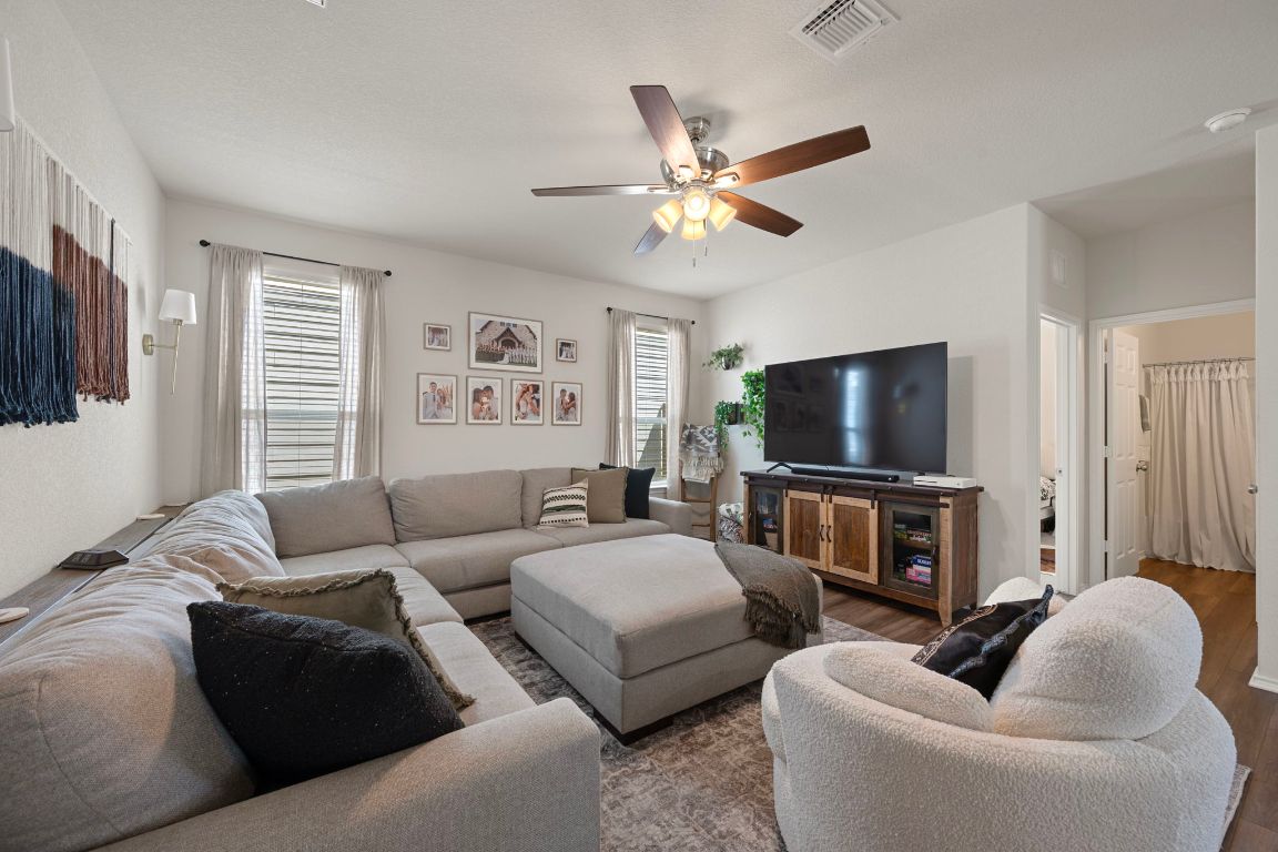 27 Pacific Loon Street Leander, TX 78641 - Photo 7 of 35 a living room with furniture and a flat screen tv