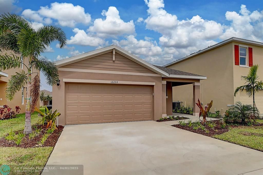 12259 Rimini Way Port St. Lucie, FL 34987 - Photo 1 of 26 a front view of a house with a yard and garage