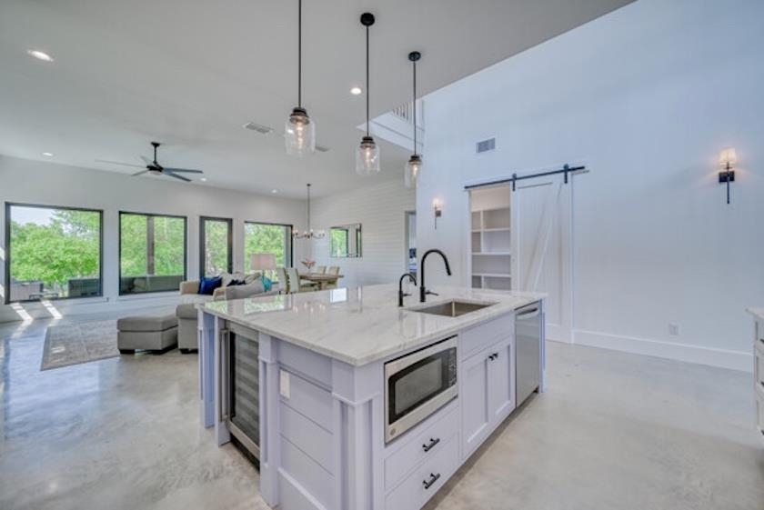 1018 River Road Burnet, TX 78611 - Photo 13 of 29 a open kitchen with stainless steel appliances granite countertop a sink and a large window