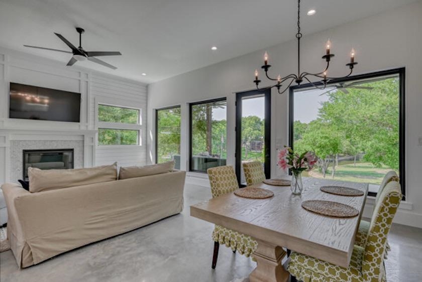 1018 River Road Burnet, TX 78611 - Photo 14 of 29 a living room with furniture a flat screen tv and a large window