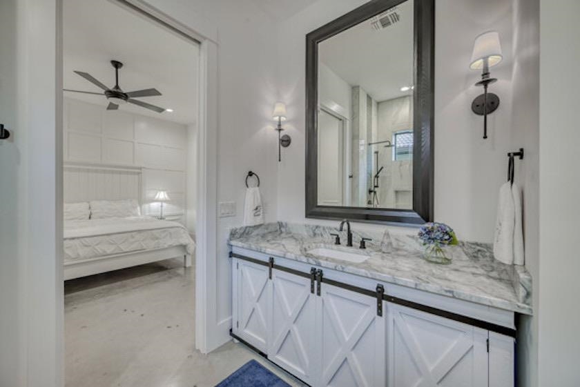 1018 River Road Burnet, TX 78611 - Photo 18 of 29 a bathroom with a granite countertop sink a mirror and a bathtub