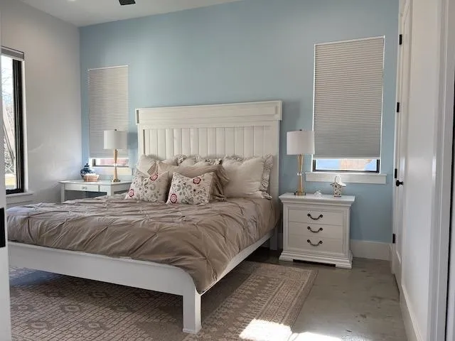a spacious bedroom with a bed and window