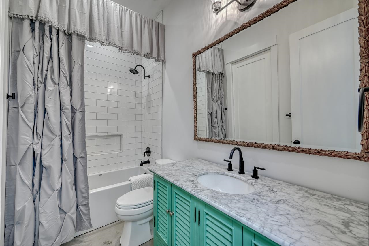 1018 River Road Burnet, TX 78611 - Photo 27 of 29 a bathroom with a granite countertop sink and a mirror