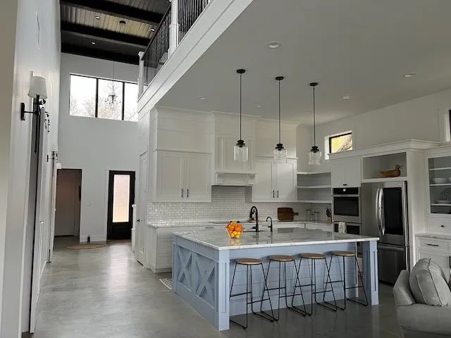 a kitchen that has a lot of cabinets in it and appliances