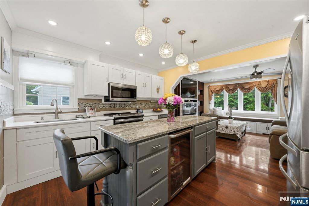 52 Barbara Drive Pompton Lakes, NJ 07442 - Photo 10 of 30 a kitchen with a stove a sink a microwave a dining table and chairs
