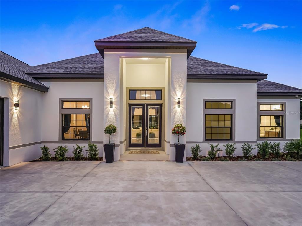7041 Northeast 22nd Ct Road Ocala, FL 34479 - Photo 12 of 73 a front view of a house with barbeque