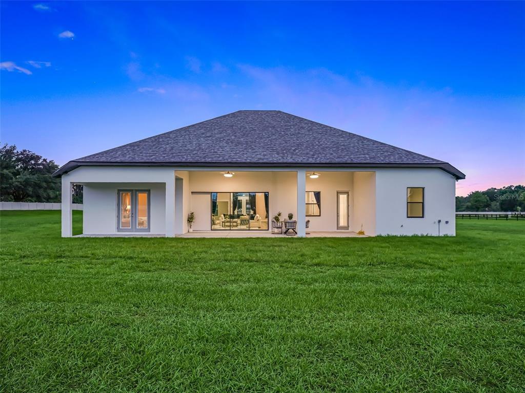 7041 Northeast 22nd Ct Road Ocala, FL 34479 - Photo 14 of 73 a front view of house with backyard and green space