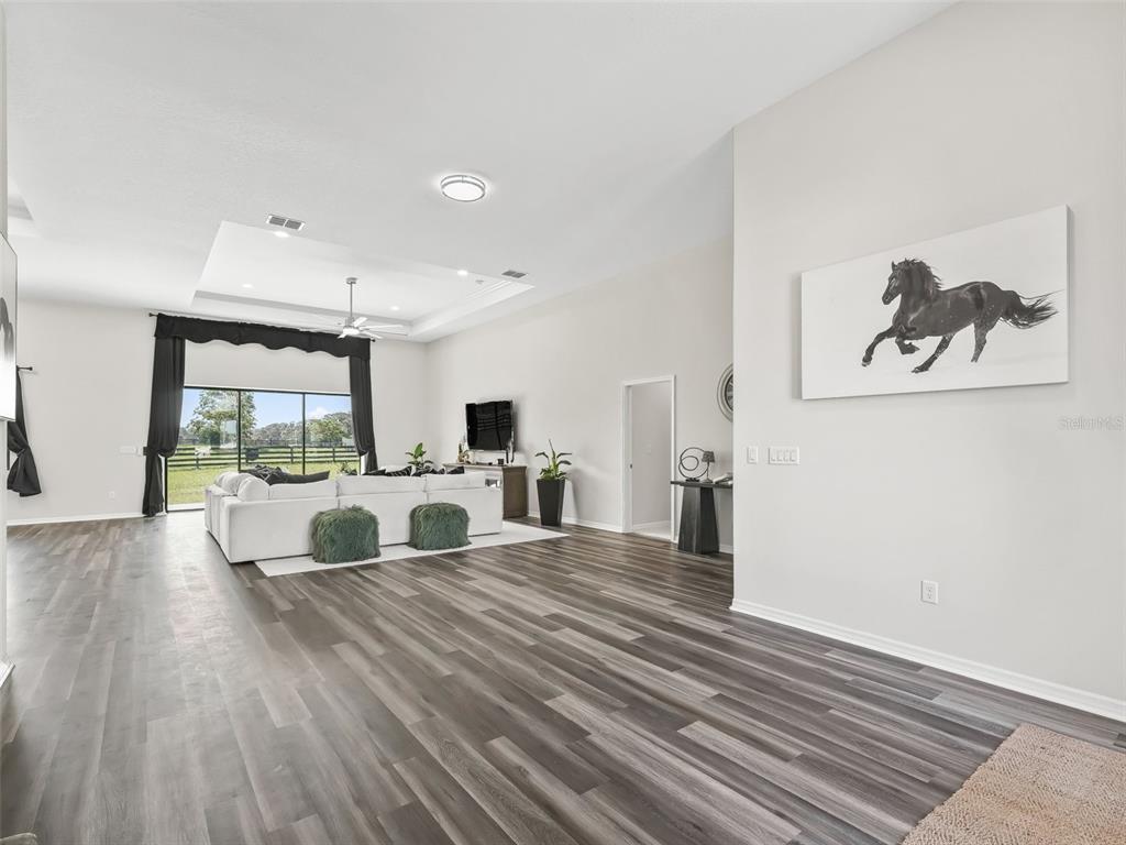 7041 Northeast 22nd Ct Road Ocala, FL 34479 - Photo 17 of 73 a living room with furniture and a large window