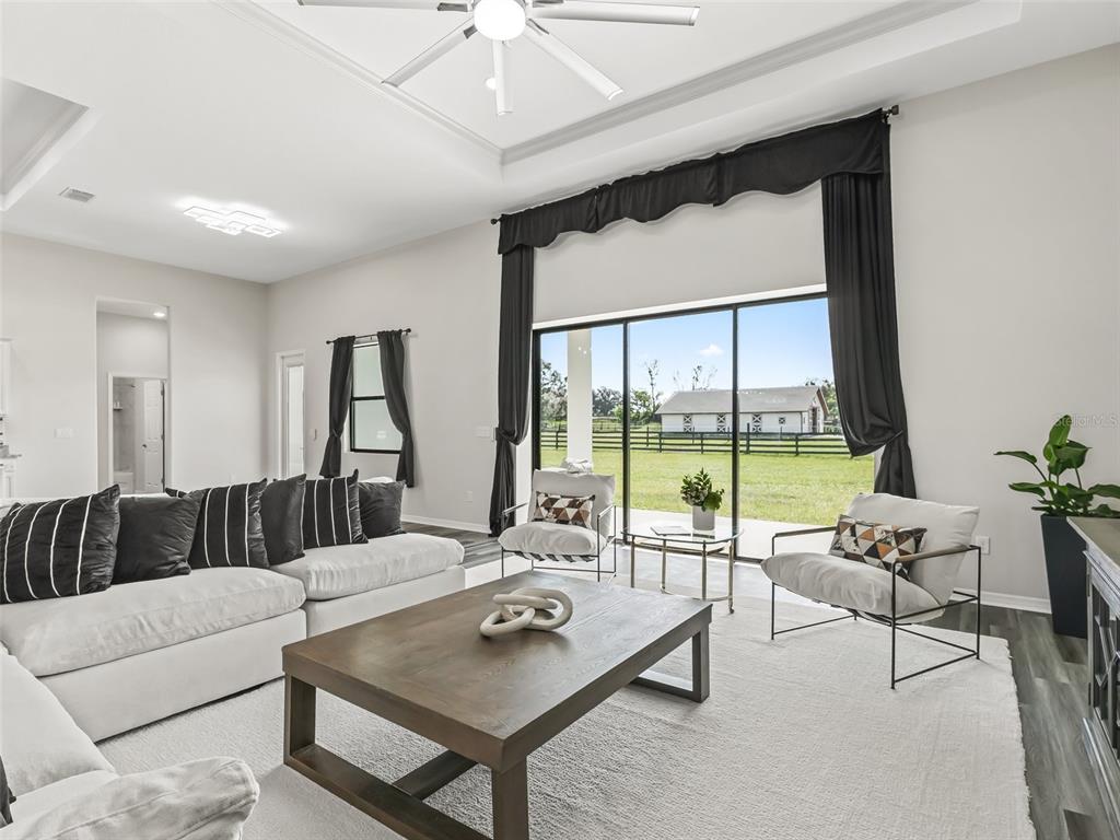 7041 Northeast 22nd Ct Road Ocala, FL 34479 - Photo 25 of 73 a living room with furniture and a large window