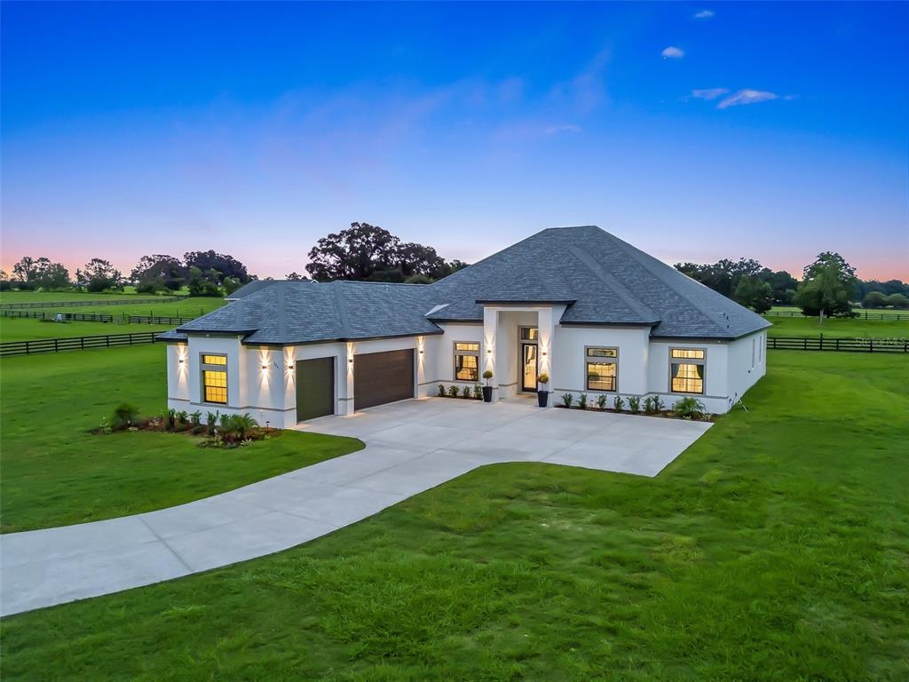 7041 Northeast 22nd Ct Road Ocala, FL 34479 - Photo 4 of 73 a front view of a house with a yard