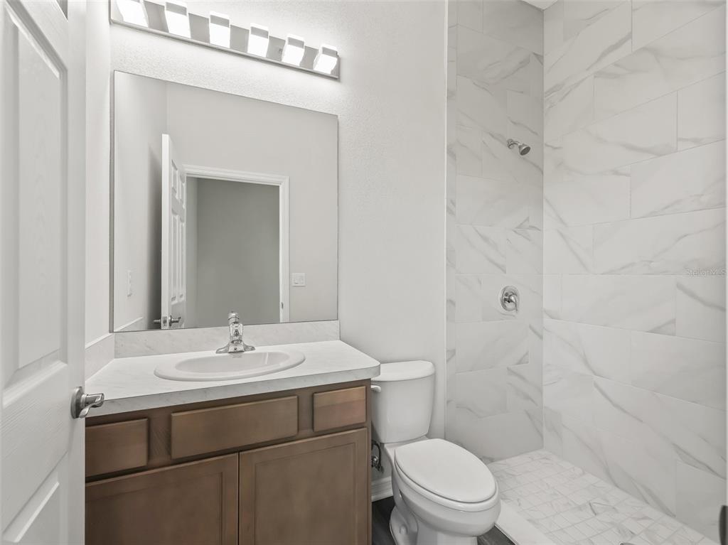 7041 Northeast 22nd Ct Road Ocala, FL 34479 - Photo 54 of 73 a bathroom with a sink toilet and shower