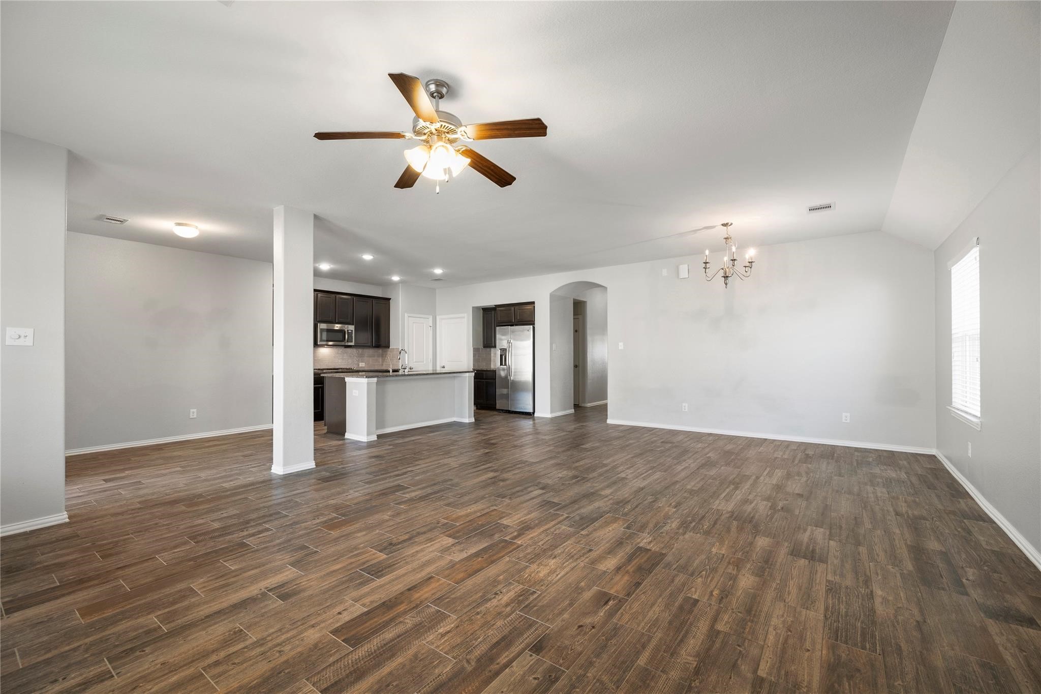 29507 Whitebrush Trace Drive Spring, TX 77386 - Photo 21 of 32 Open-concept living and dining area with wood-look flooring.