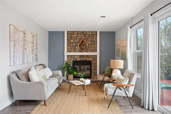 a living room with furniture and a fireplace