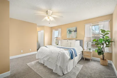 a bedroom with a bed and ceiling fan