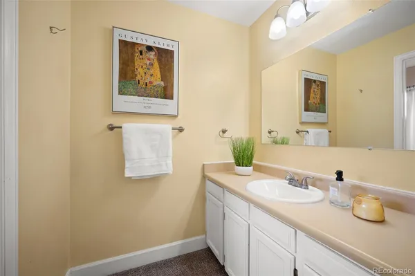 a bathroom with a granite countertop sink and a mirror