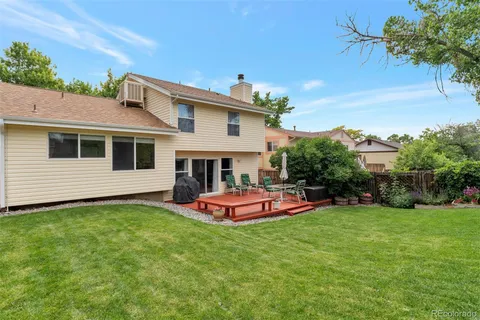 a front view of a house with a yard table and chairs