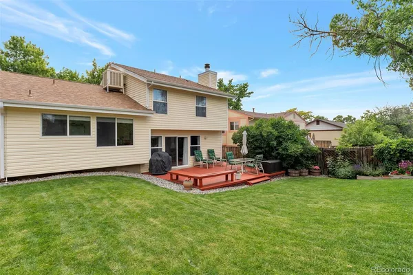 a front view of a house with a yard table and chairs
