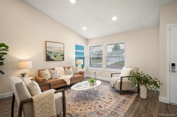 a living room with furniture and a potted plant