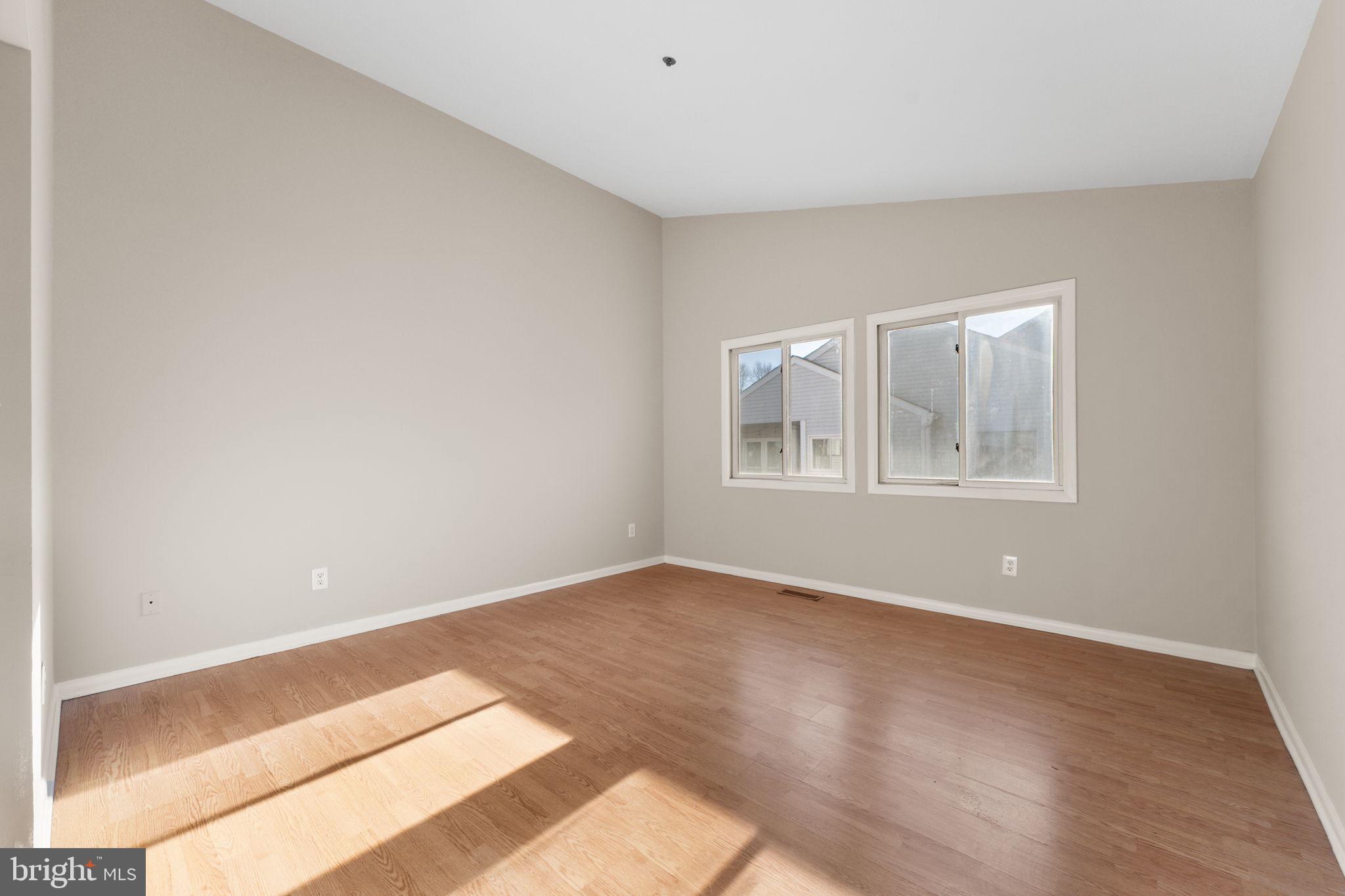 205 Michelle Court Newark, DE 19711 - Photo 24 of 37 a view of an empty room with wooden floor and a window