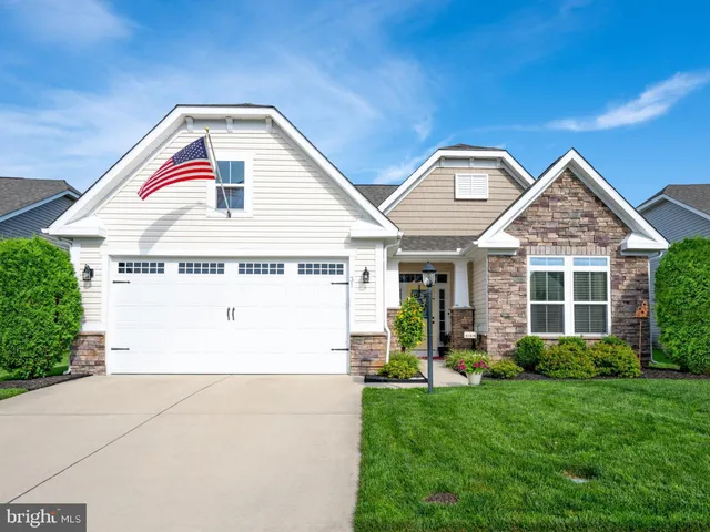 a view of a house with a small yard and plants