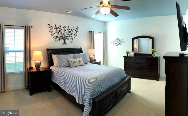 a bedroom with furniture and a flat screen tv