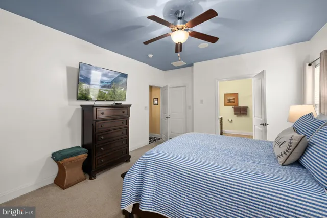 a bathroom with a sink a large mirror and a toilet