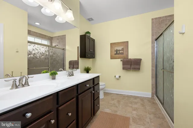 a view of walk in closet with clothes