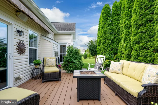 a view of a wooden chairs in patio of the house