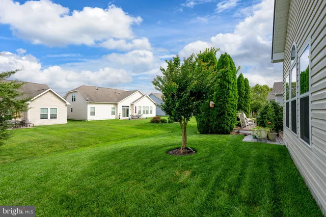 an aerial view of multiple houses with a yard