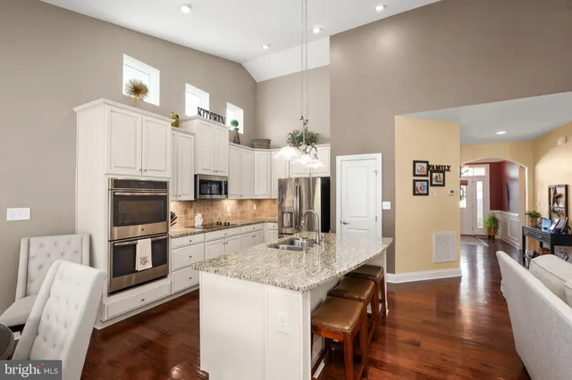 a kitchen with granite countertop a refrigerator and a sink