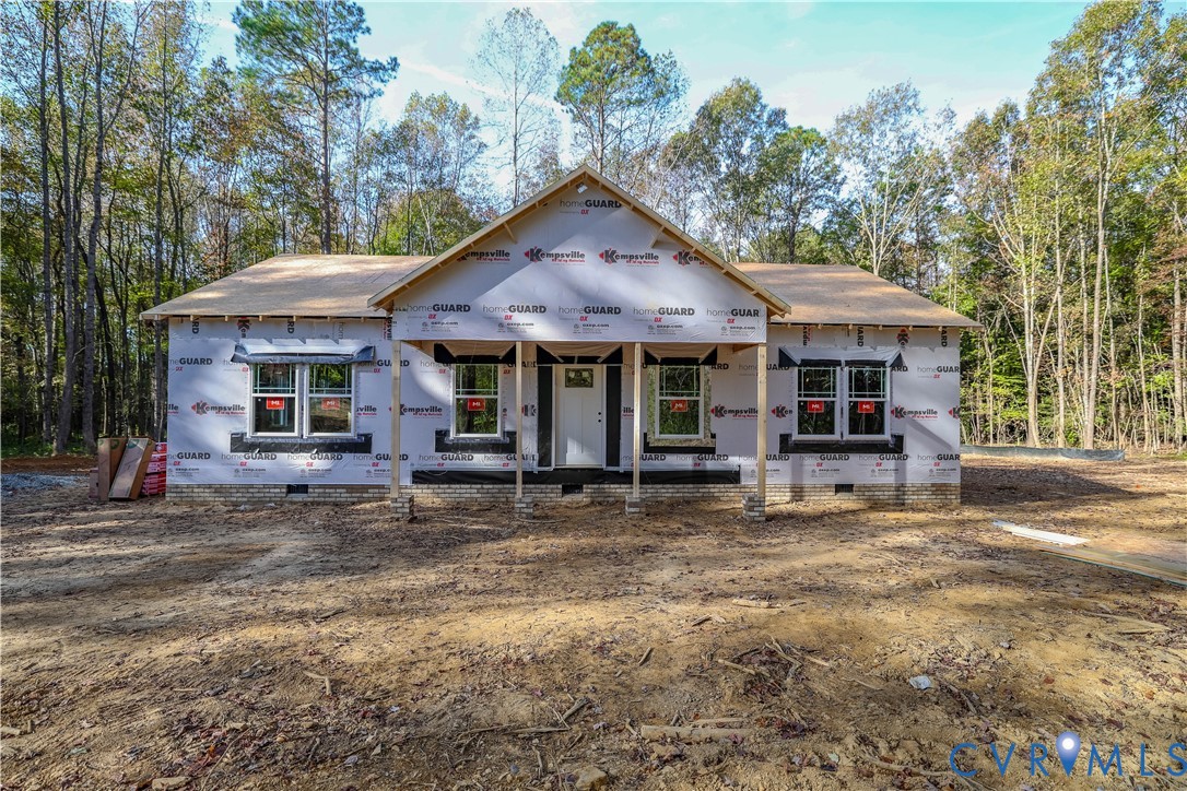 a view of a house with a yard and sitting area